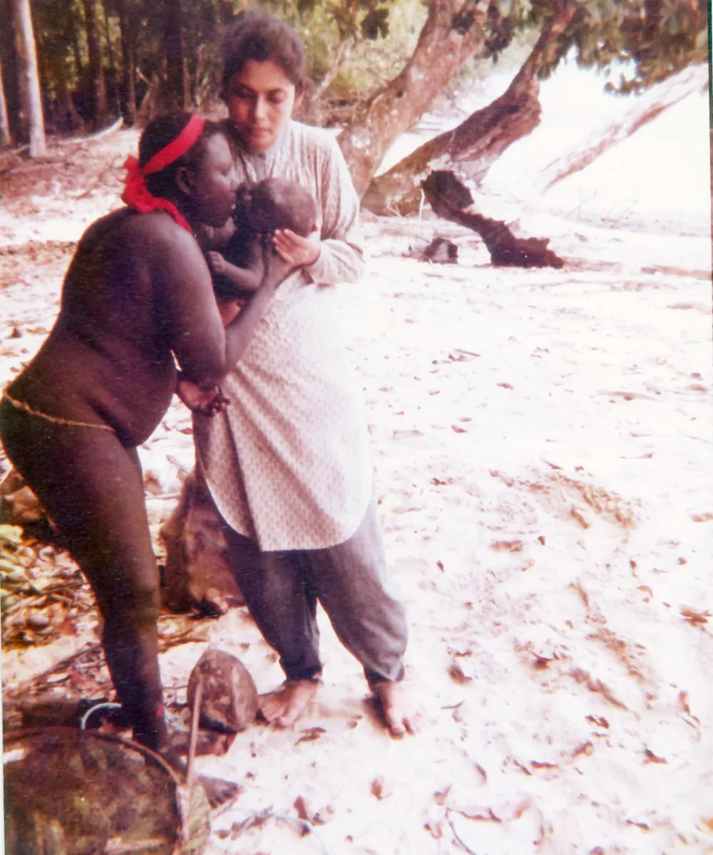 Madhumala documenting the unique mouth-to-mouth style in which Jarawa mothers feed their babies